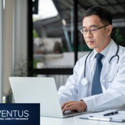 Middle aged doctor at laptop computer